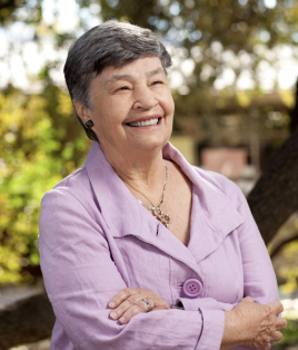 Photo of Lucy Nazro smiling with her arms crossed.
